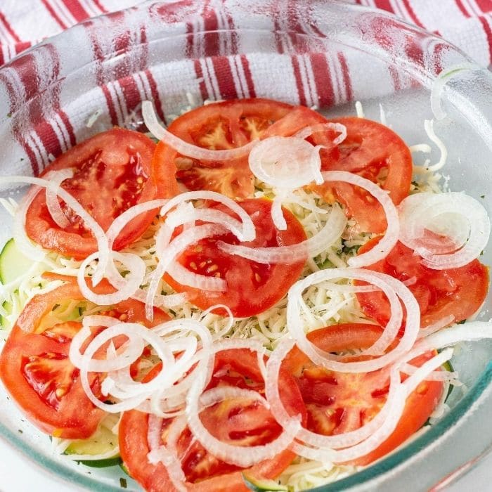 tomatoes and onions in a pie dish on counter 