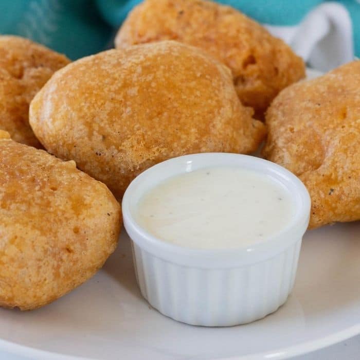 Deep fried pickles on a plate with dipping ranch 