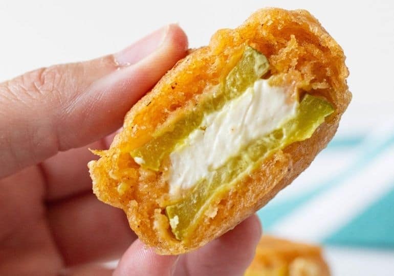 holding a fried pickle