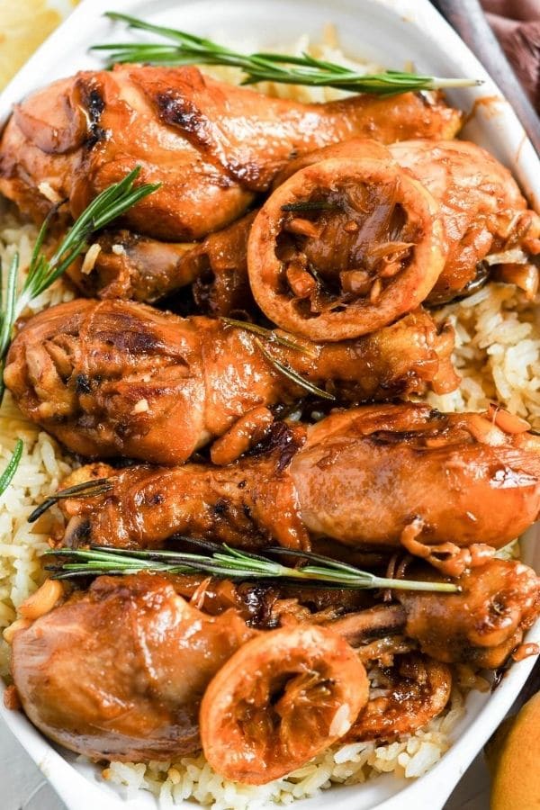 chicken legs over rice in oval cookware 