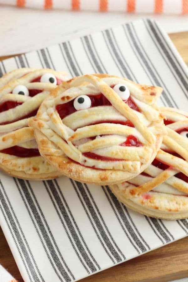 mummy hand pies on a plate stacked up 