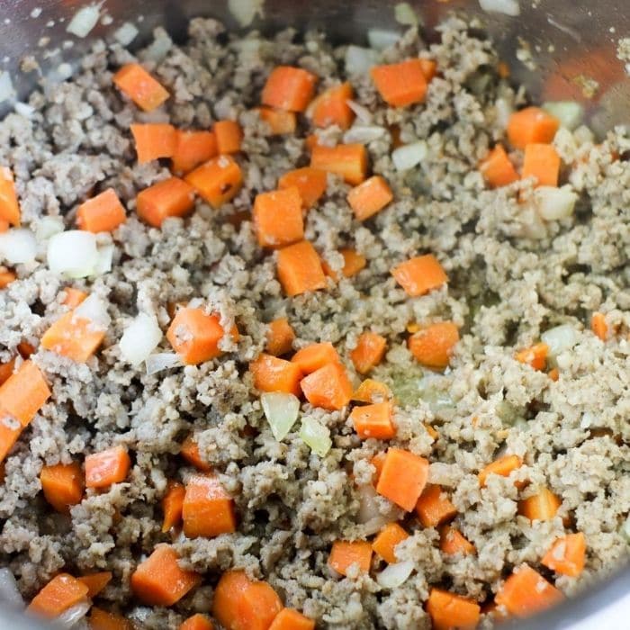 sausage, carrots, and onions cooking in Instant Pot 