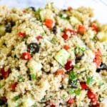 quinoa salad in a glass bowl on table