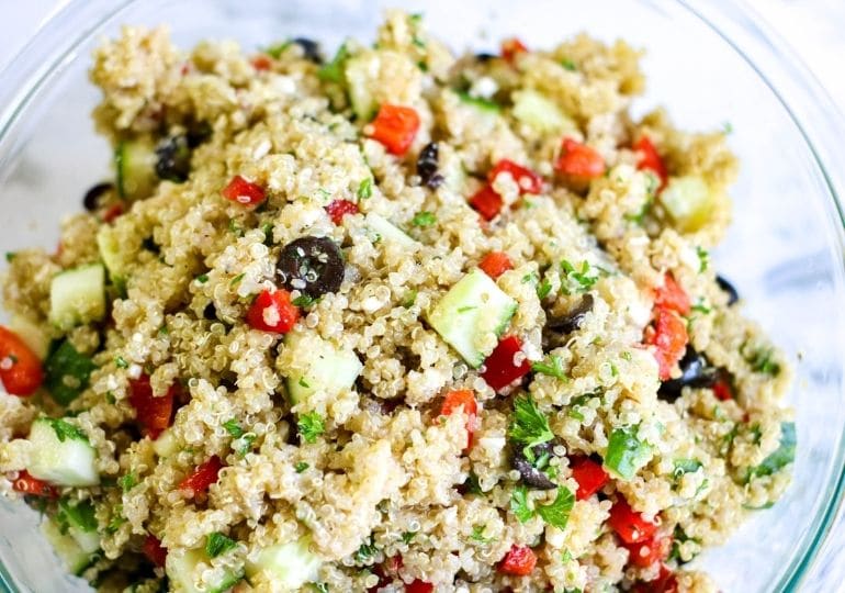 quinoa salad in a glass bowl on table