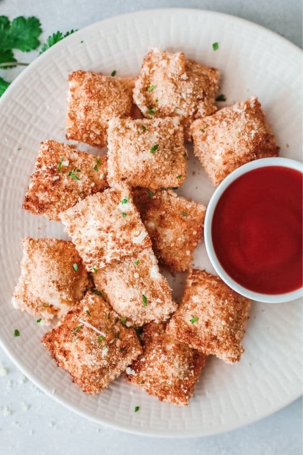 air fried ravioli on a plate with sauce 