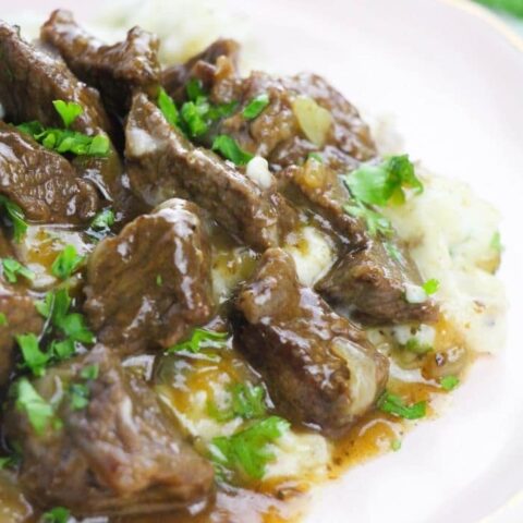 plate of beef, gravy and mashed potatoes