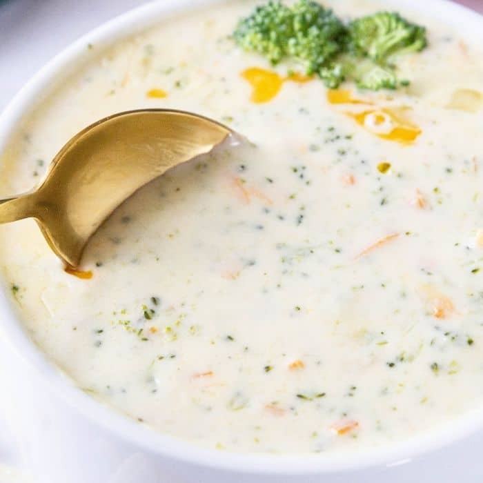 spoon dipping in broccoli cheese soup bowl 