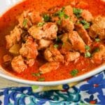 butter chicken on bowl with napkin by it on table