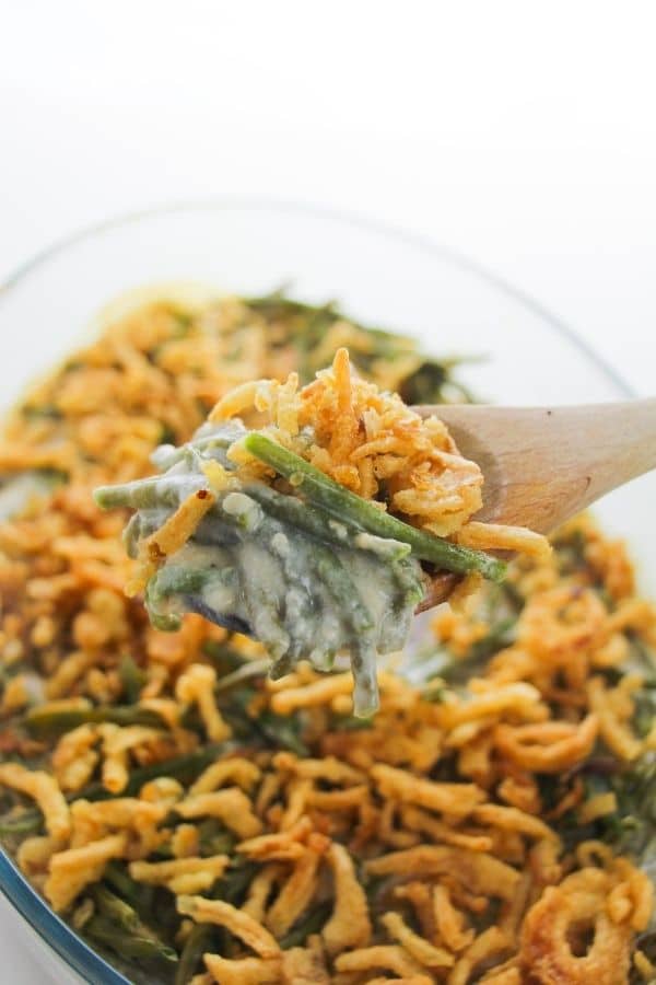 wooden spoon holding green bean casserole 