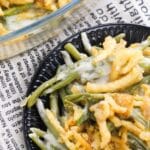 green bean casserole on table with newpaper cloth behind it