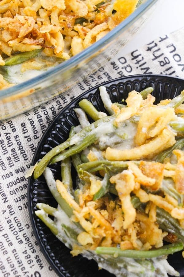 green bean casserole on table with newpaper cloth behind it 