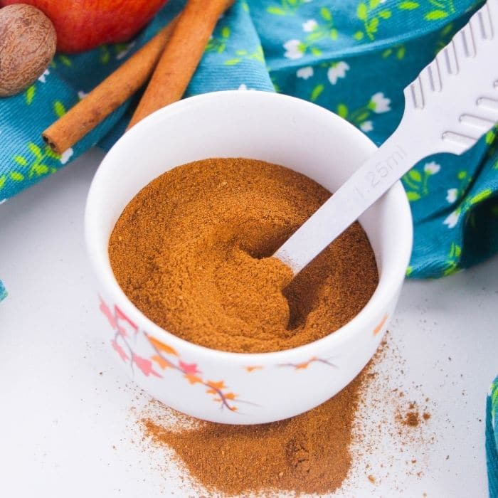 bowl of spices and measuring spoon inside it 