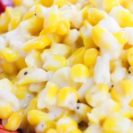 creamed corn on a red plate