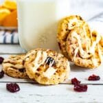 dried cranberry cookies iced, with milk behind it