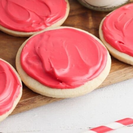 cutting board with sugar cookies on top