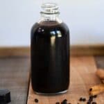 glass elderberry syrup in bottle