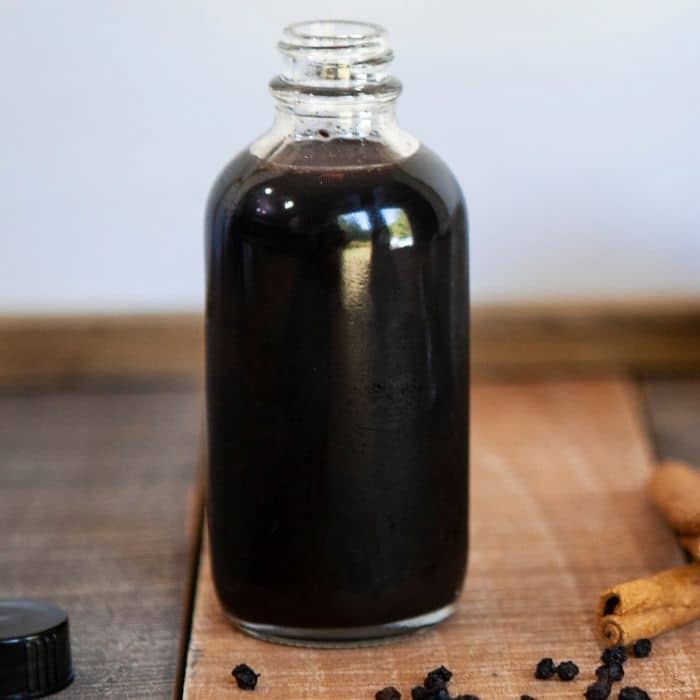 glass elderberry syrup in bottle 