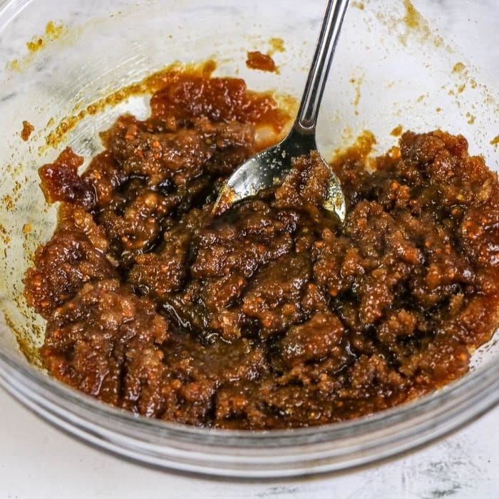  a brown sugar glaze in a bowl with spoon