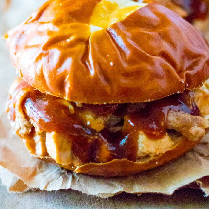 bbq cranberry pork sandwich on pretzel bun