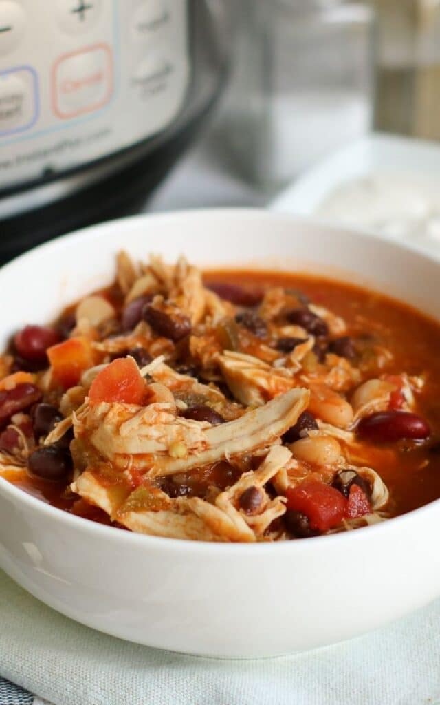 side view of a bowl of chicken chili with beans 