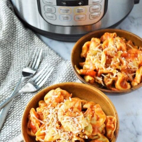 bowls of pasta with instant pot behind the bowls