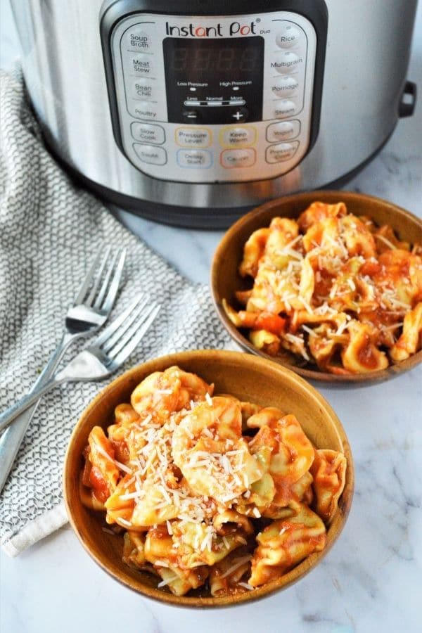 bowls of pasta with instant pot behind the bowls 