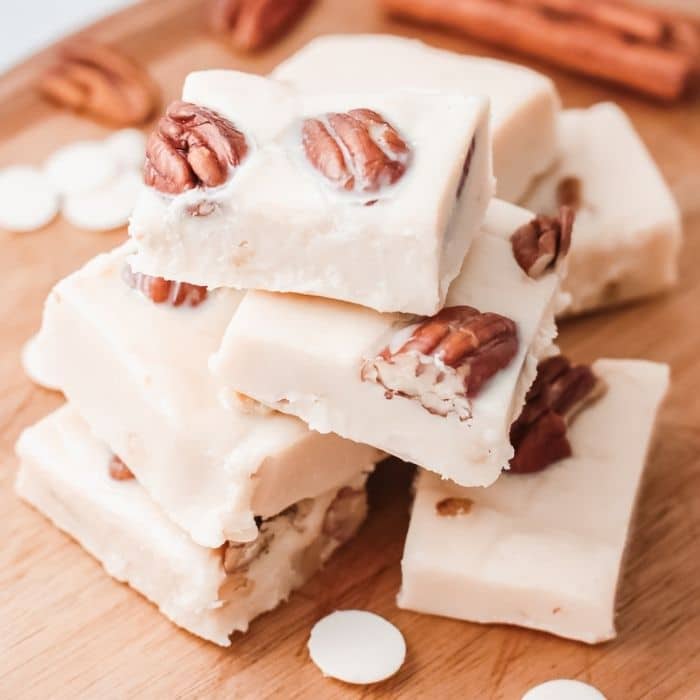 homemade fudge sliced and stacked on cutting board 