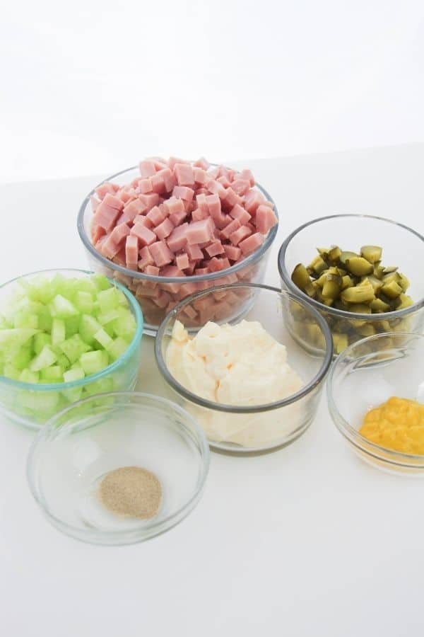 ingredients in glass bowls for making ham salad