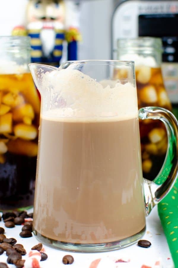 mocha peppermint creamer in a pitcher with iced coffee behind it