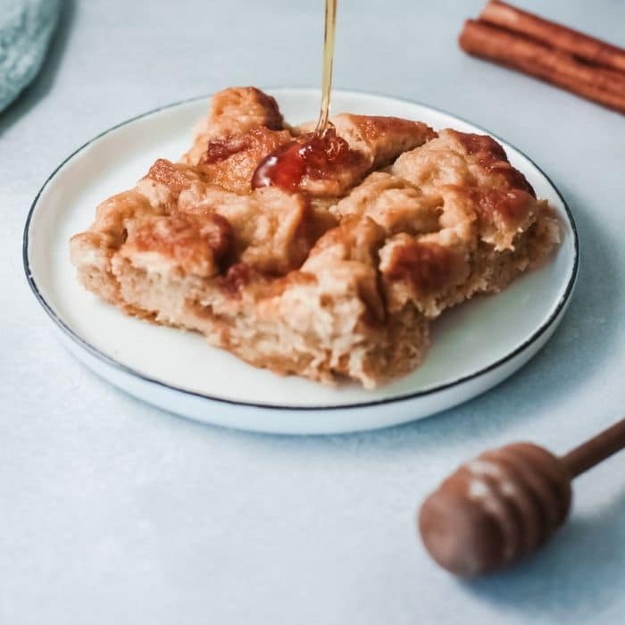 french toast bake on a plate with syrup drizzled on 