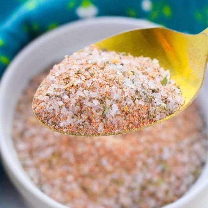 spoon of season salt above bowl