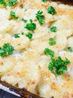 casserole with potatoes topped with parsley