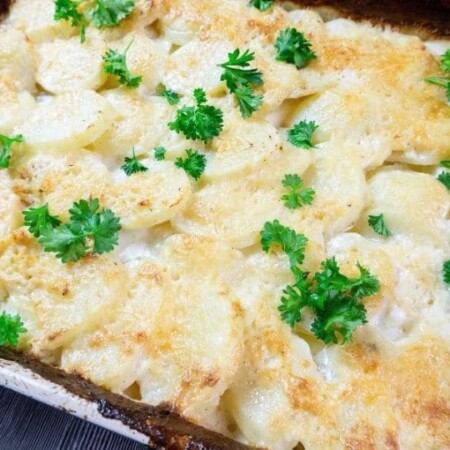 casserole with potatoes topped with parsley