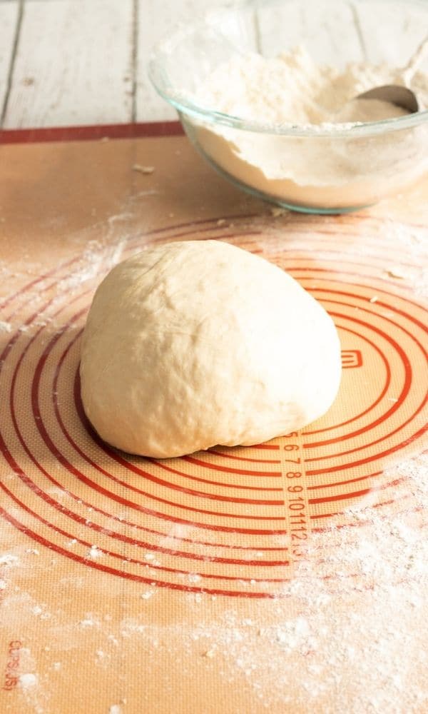 bread dough on a silpat pad on table 