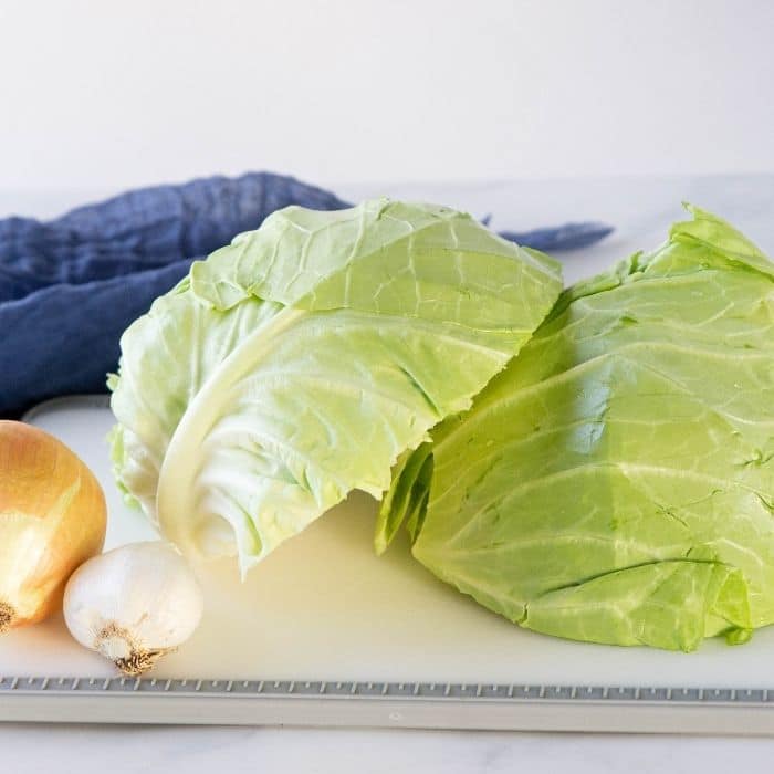 cabbage  onion and garlic on cutting board on table