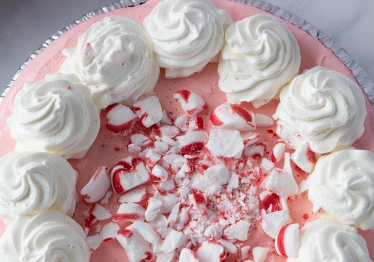 christmas cheesecake overhead shot with crushed peppermints in center of pie