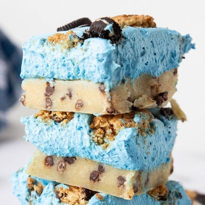 cookie cheesecake bars stacked on top of each other