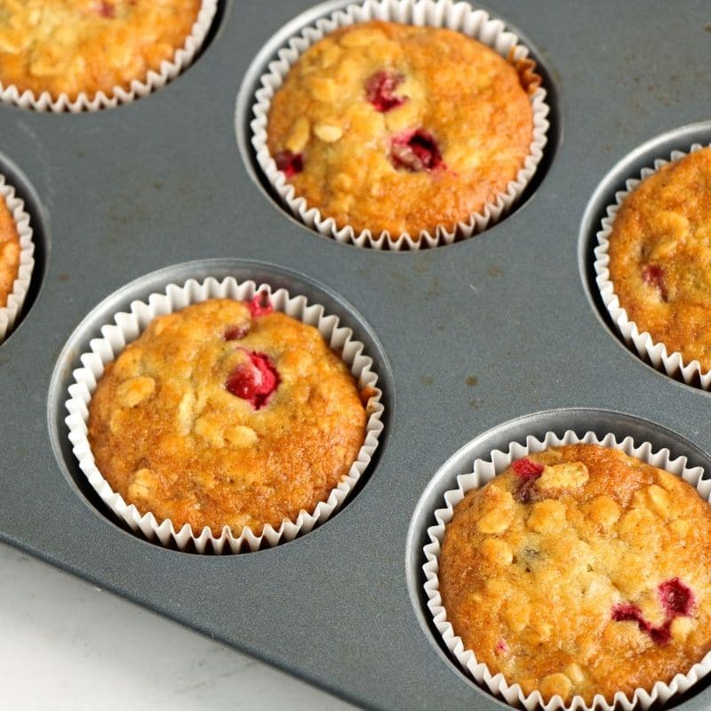 cranberry muffins in a muffin tin 