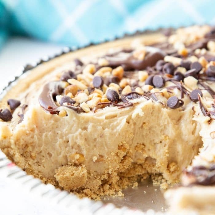 fluffy peanut butter pie with slice taken out of it 
