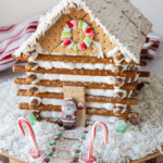 log cabin house on table with coconut shavings around it