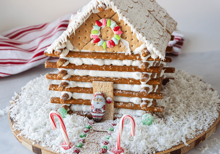 log cabin house on table with coconut shavings around it