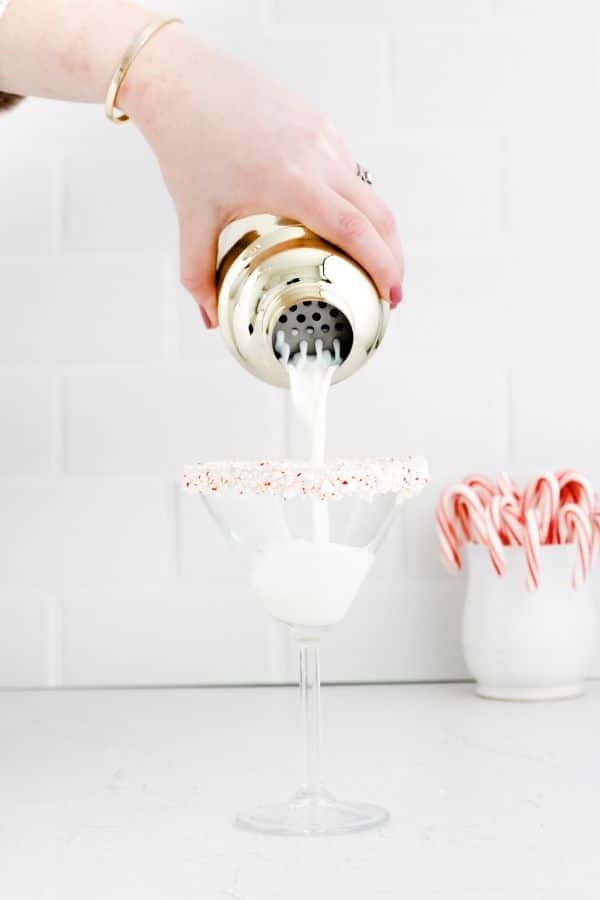 pouring martini into glass