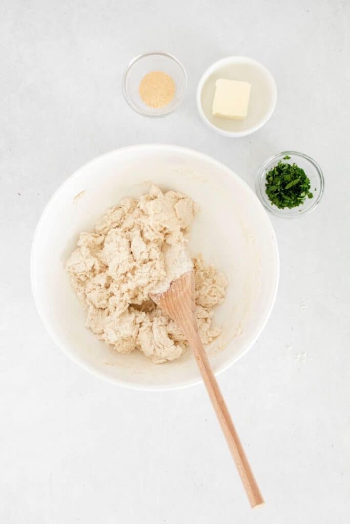 bowl with bisquick and ingredients around it for homemade biscuits