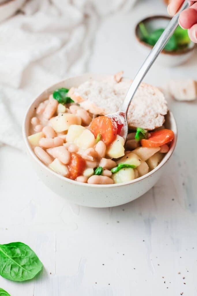 ninja foodi bean soup on counter with spoon in it 