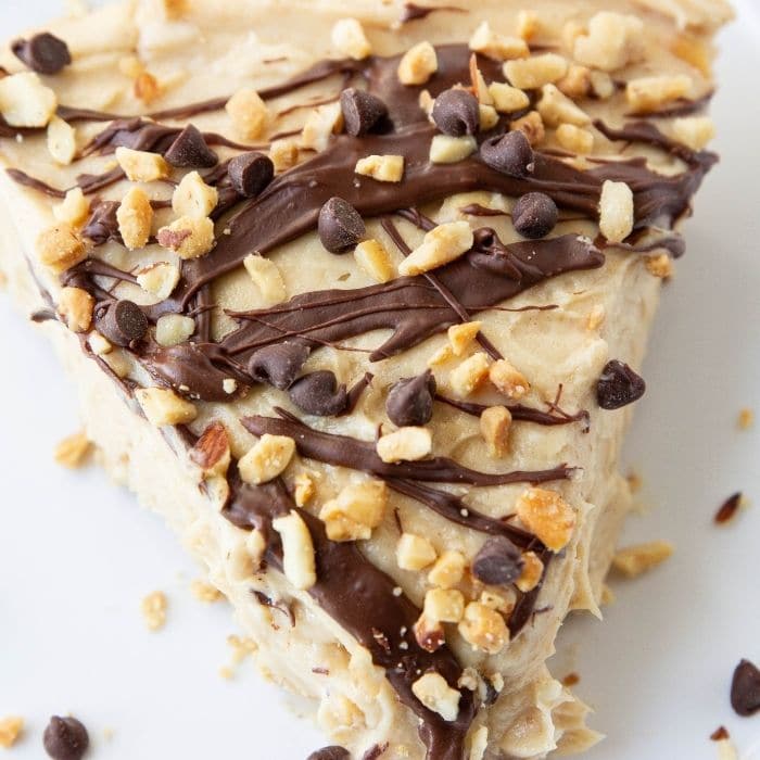 no bake pb pie on plate with nuts and chocolate chips by it 