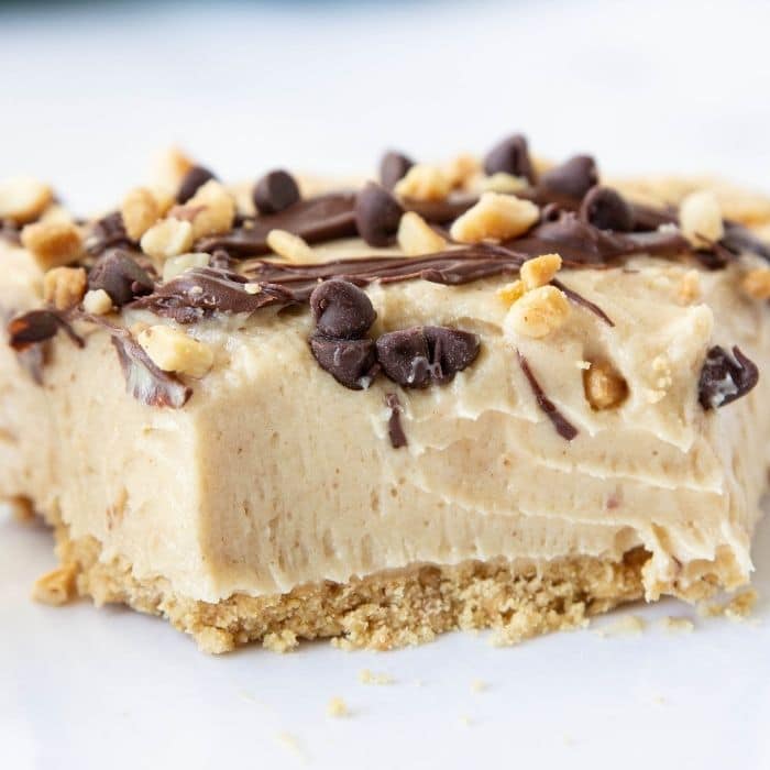 peanut butter cream cheese pie with a piece cut out of it