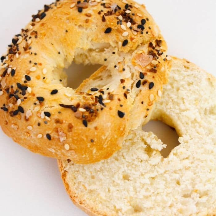 sliced bagel on counter with everything bagel seasoning on top 