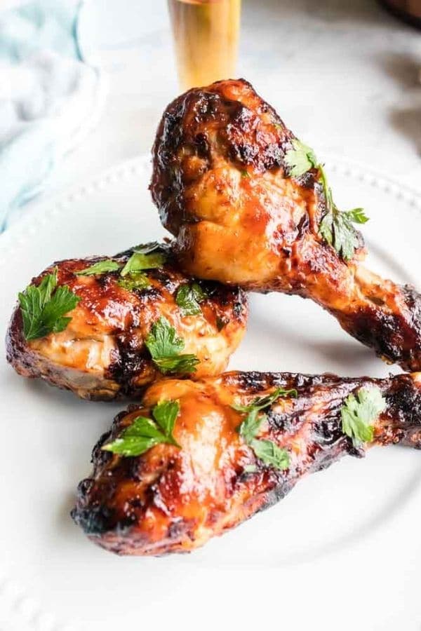 air fryer chicken legs on a white plate on table 