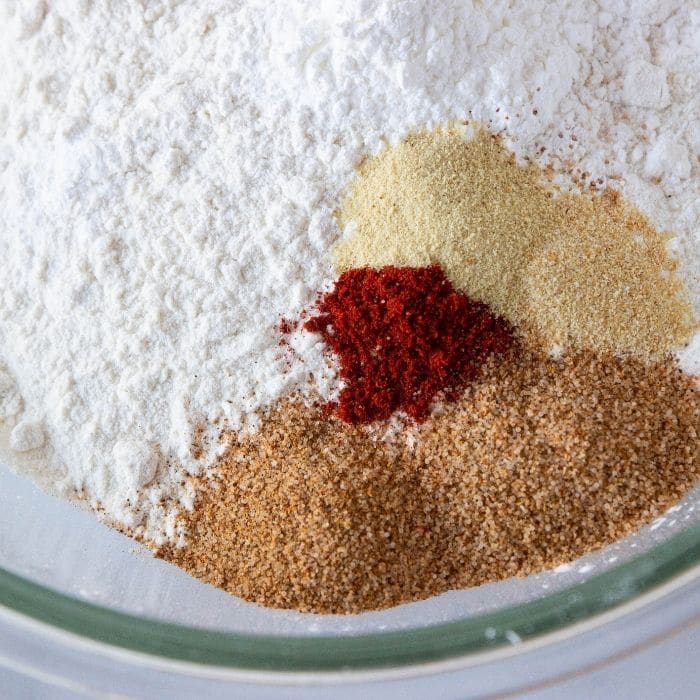 spices and flour in a bowl on marble counter