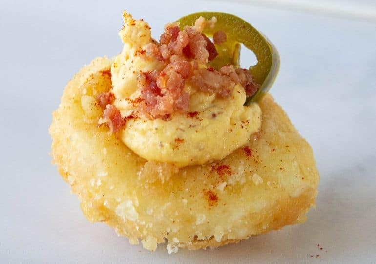 fried deviled eggs with bacon and jalapeno on counter